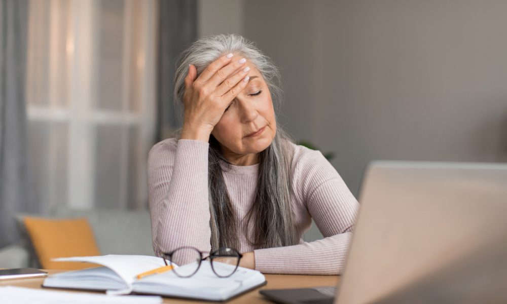 Depressed tired european mature woman with gray hair suffers from headache, got stress and unhappy face Four in five women complain about menopause support in the workplace, finds UK survey