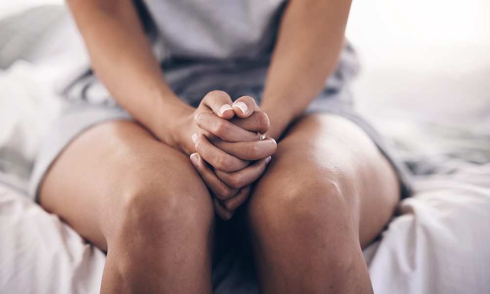 Hands together, stress and praying black woman with depression and mental health problem in bed. Home, prayer and psychology help of a person ready for counselling feeling anxiety and depressed ‘The capacity for harm is real’- experts raise concerns over use of AI in reproductive health
