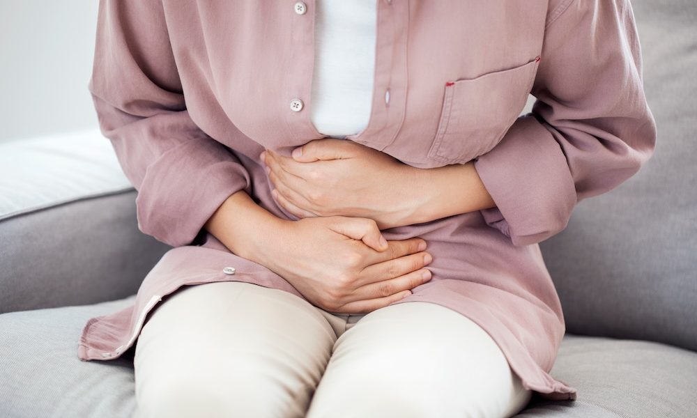 Young woman with stomach pain Everything you need to know about fibroids
