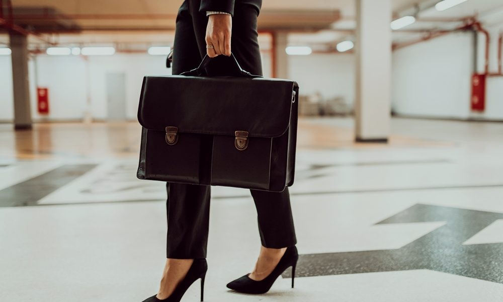 business-woman-suit-with-briefcase-her-hand-goes-work-selective-focus-business-concept-high-quality-photo What Defines a Modern Ladies’ Professional Briefcase?