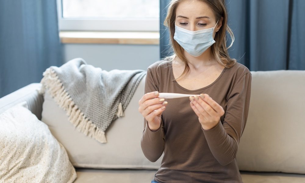 woman-with-mask-staying-quarantine-couch Covid vaccine not linked to decrease in childbirth, study finds