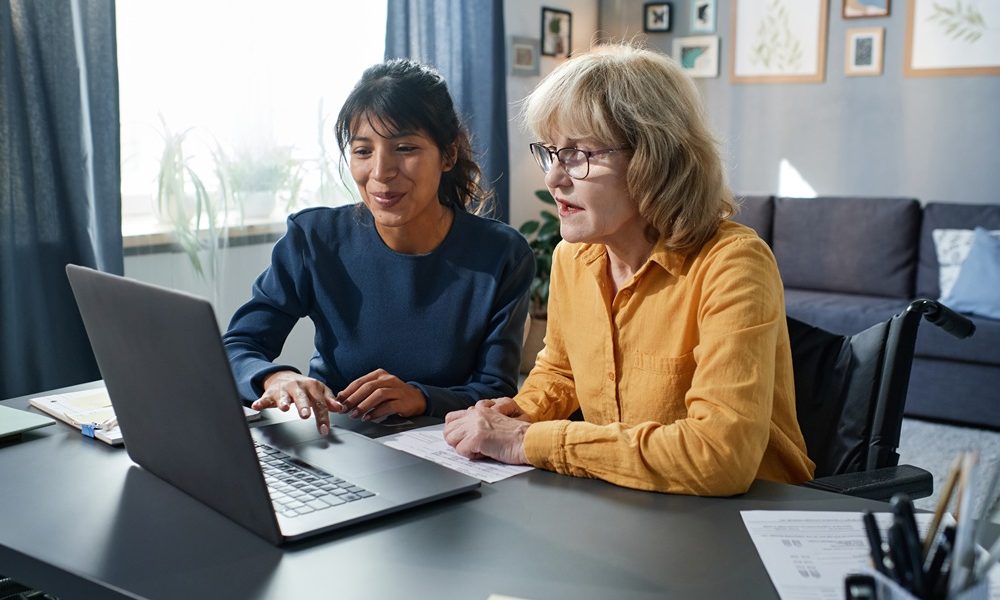 young-volunteer-showing-senior-woman-how-use-computer-while-they-sitting-table-living-room Women still being failed when they reach menopause, experts say