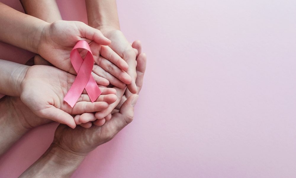 hands holding pink ribbons, Breast cancer awareness and October Pink day Breast cancer rising rapidly in Asian American women, study finds