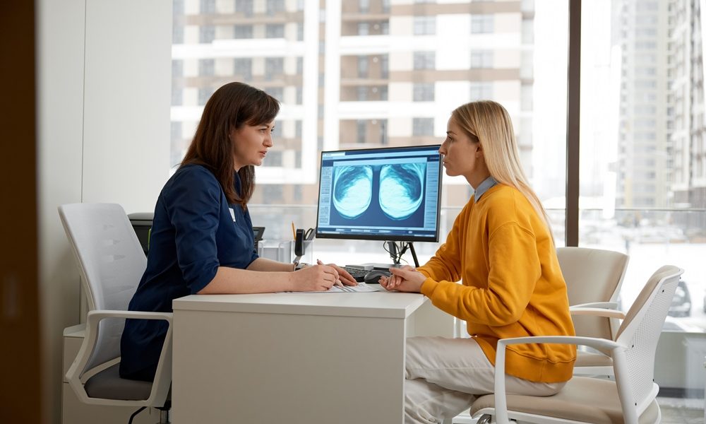 woman-doctor-explaining-xray-scan-patient-medical-appointment AI analysis of mammograms can detect heart disease, study suggests