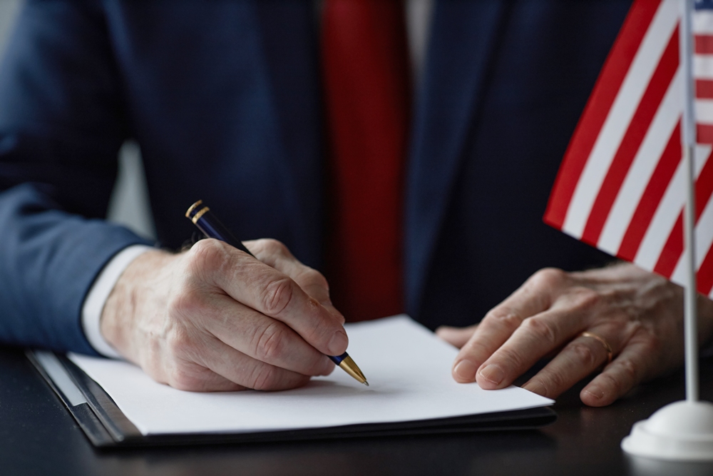 middle-aged-male-politician-signing-document-business-meeting Trump signs executive order to establish NIH women’s health division